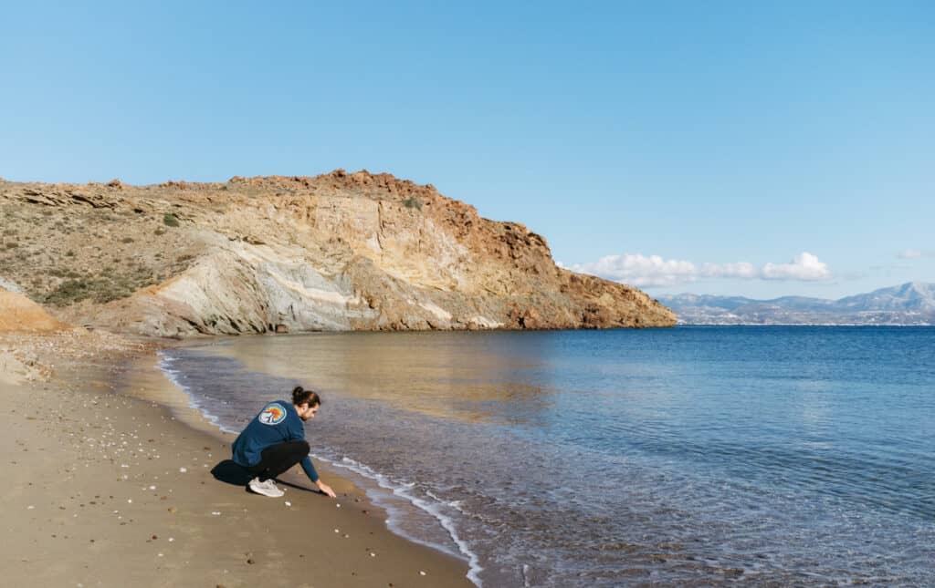 Caleb admiring the water at Kalogeros Beach. The scene is very serene and peaceful