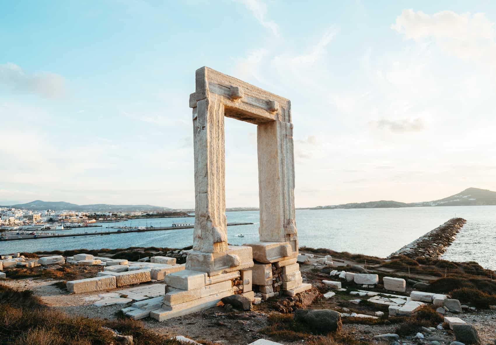 Portara in Naxos, also called the Temple of Apollo in Greece. You can see Naxos Port and the ocean in the background