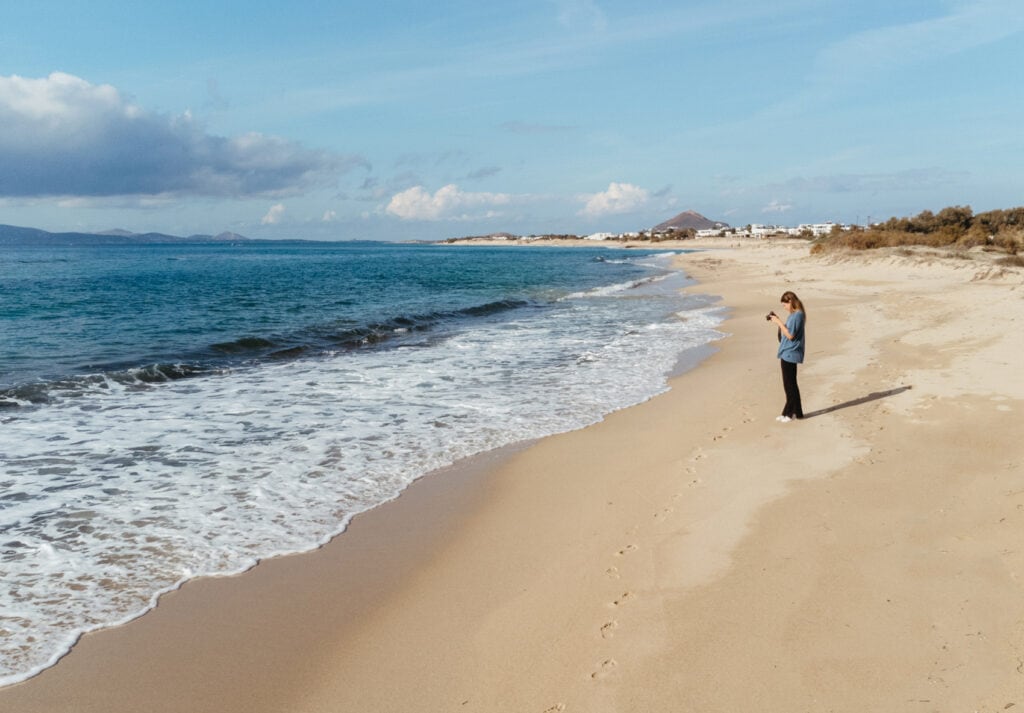 Sarah standing in the sand in Plaka Beach, Naxos.