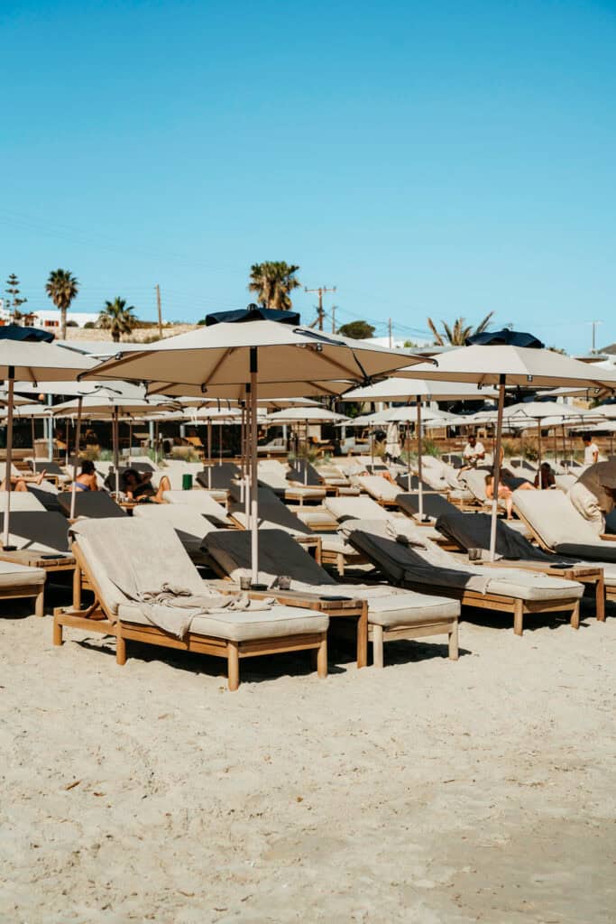 Close-up view of sunbeds and umbrellas on the sandy shore at Marcello Beach Paros