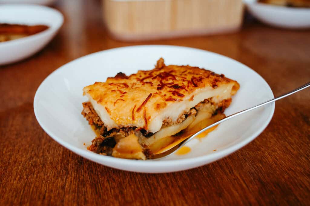 Traditional Greek moussaka served on board during one of the best boat tours in Naxos, offering a taste of authentic local cuisine at sea.
